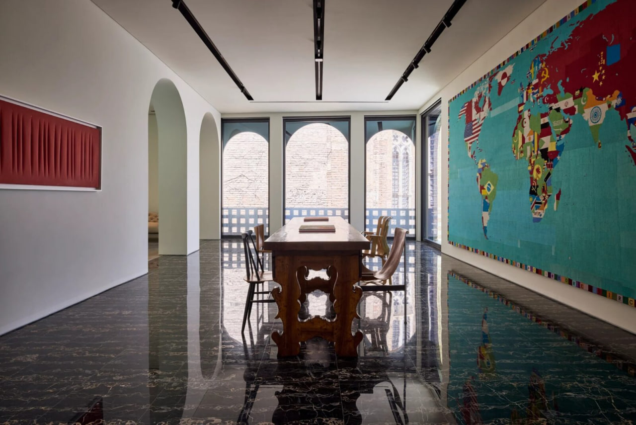 Marble floor meeting polished concrete, old brick adjoining new glass partition.